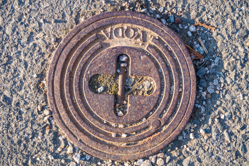 Texture of Metal cover for water, sewer manhole, With the inscription - Water