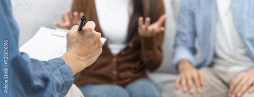couple relationship therapy with a counselor. Close Up hands of the woman client during a conversation with psychologist to find problems and solution. © Pormezz