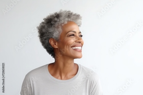 Dark skin woman with smooth healthy face skin. Beautiful aging mature woman with short gray hair and happy smiling 
