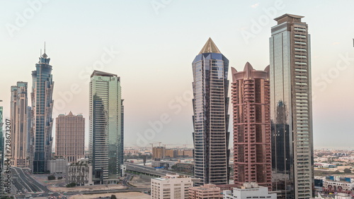 Business bay district skyline with modern architecture night to day timelapse from above. © neiezhmakov
