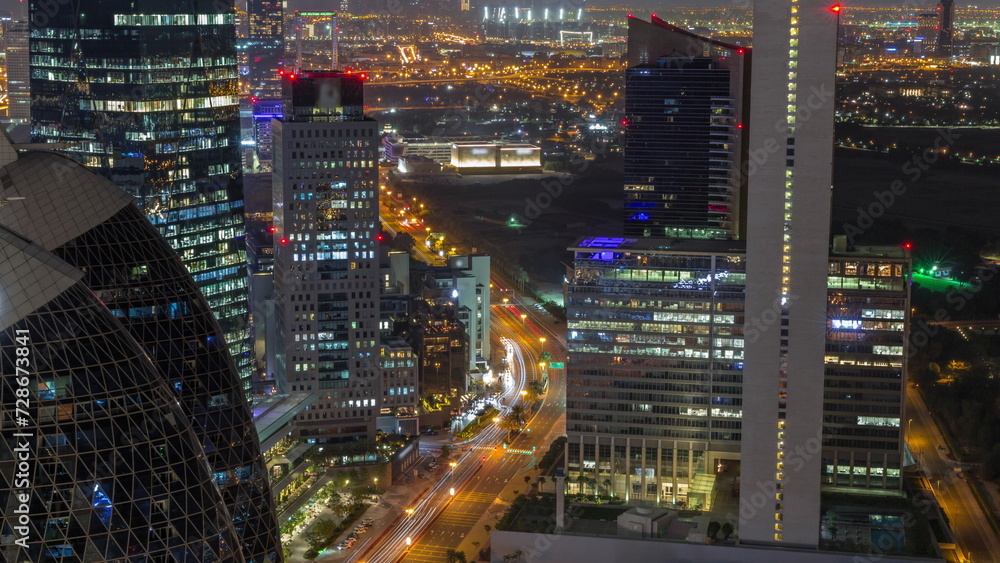 Skyline view of the high-rise buildings in International Financial Centre in Dubai aerial all night timelapse, UAE.