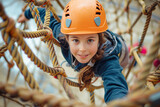 A girl passes an obstacle in a rope town. A girl in a forest rope park. Side view of curly american little child climbing with rope at playground.