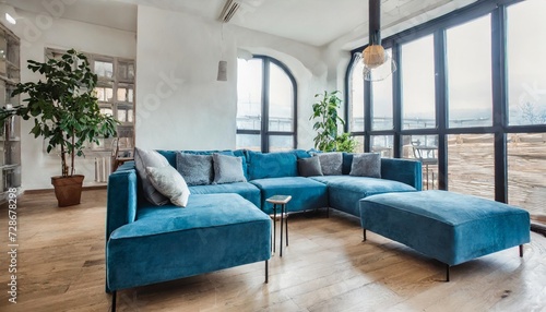 scandinavian style interior design of modern living room with blue big sofa light oak floor big windows © Emanuel