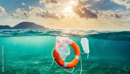ocean plastic pollution concept with plastic waist and lifebuoy floating in the ocean or sea photo