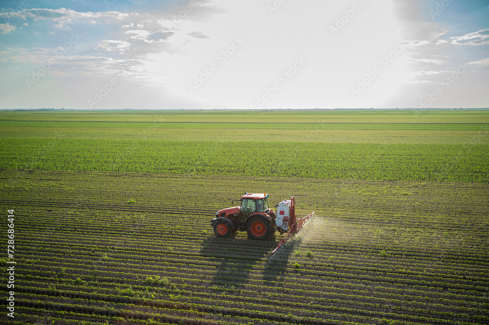 Fototapeta premium Spraying pesticides at soy bean fields