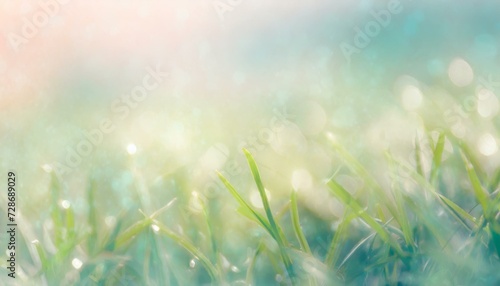 Pale springtime background with green meadow grass blades and copyspace. 