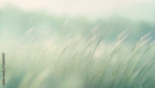 Pale springtime background with green meadow grass blades and copyspace. 