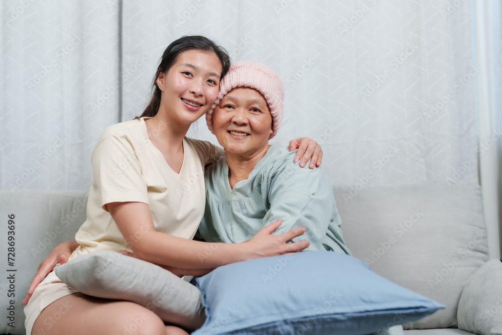 beaming daughter sits with her ailing mother, sharing a joyful moment, faces touched by smiles. Joy and resilience shine as a young woman and her mother with cancer share a close, happy connection beaming daughter sits with her ailing mother, sharing a joyful moment, faces touched by smiles. Joy and resilience shine as a young woman and her mother with cancer share a close, happy connection