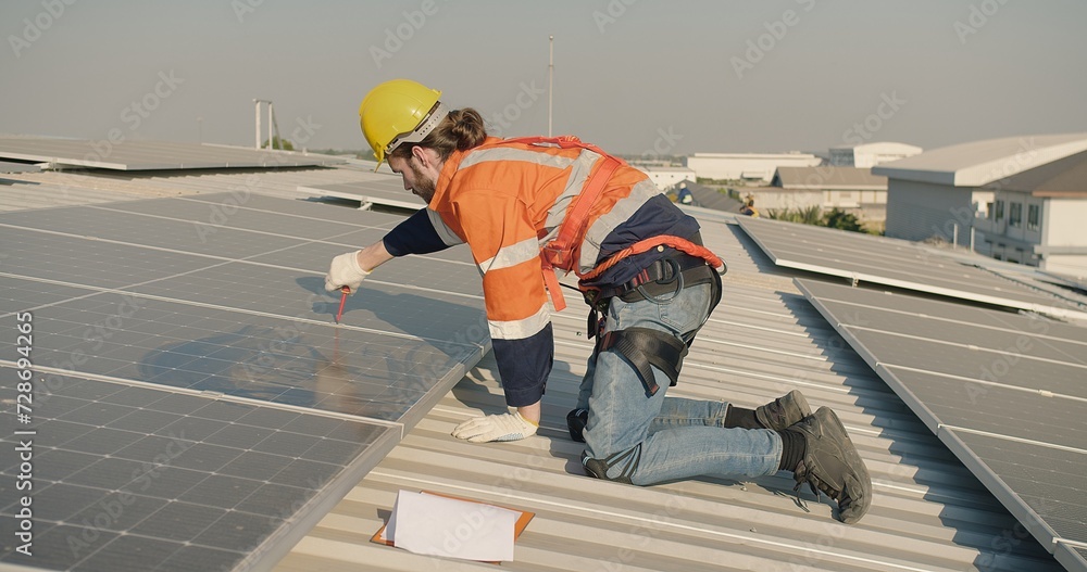 engineer Technician in safety gear installs solar panels on a roof under a clear sky, with a clipboard and tools nearby engineer Technician in safety gear installs solar panels on a roof under a clear sky, with a clipboard and tools nearby