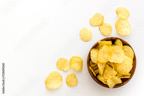 Homemade low calorie crispy potato chips in bowl, top view