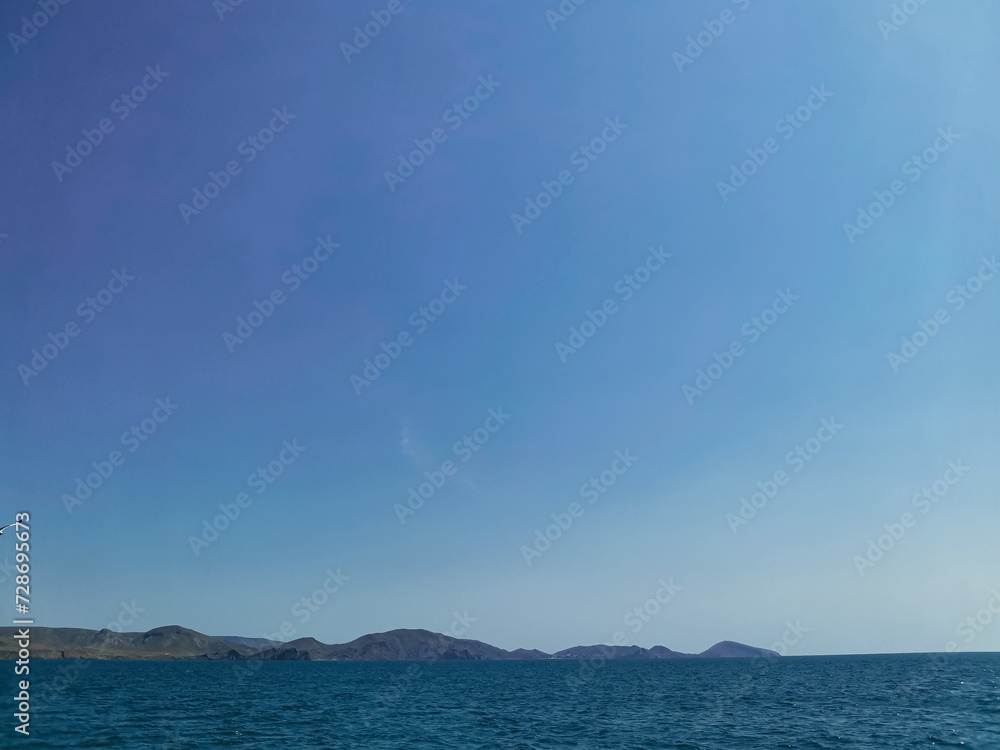 Sunny Summer Landscape of Sea, Mountains, and Sky with No People Sunny Summer Landscape of Sea, Mountains, and Sky with No People