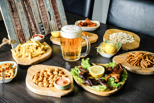 Table With Food Plates and Mug of Beer