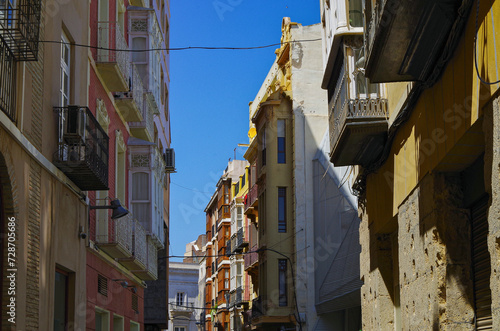 Romantic backstreet, side street and alleys in historic old town of Cartagena, Spain with historic Spanish style architecture facades, a landmark sightseeing tourist spot in downtown