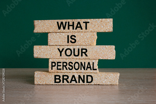 What is your personal brand symbol. Concept words What is your personal brand on brick blocks. Beautiful wooden table, green background. Business what is your personal brand concept. Copy space. photo