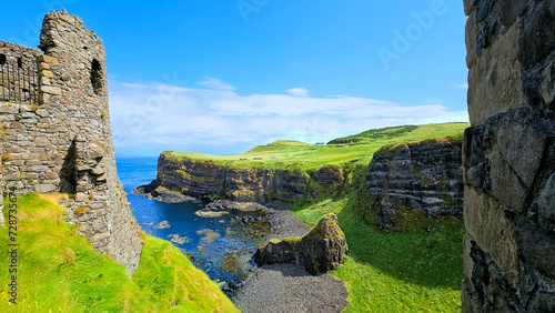 Northern Ireland view of the green Causeway coast through ancient castle ruins