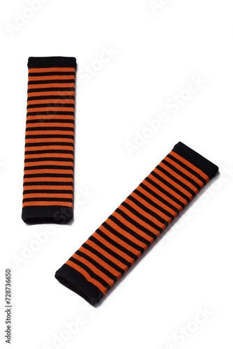 Subject shot of striped black and orange elbow length mittens. The pair of fingerless gloves is isolated on the white background. photo