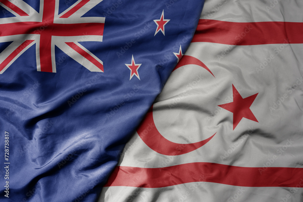 Fototapeta premium big waving national colorful flag of northern cyprus and national flag of new zealand .