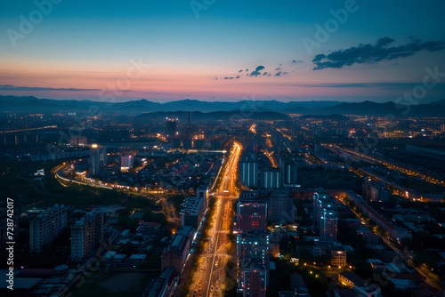 Aerial view of a bustling commercial district at twilight, city lights
