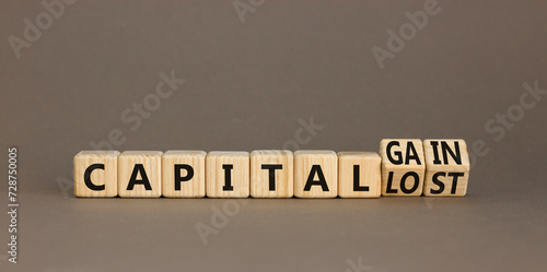 Capital loss or gain symbol. Concept words Capital loss to Capital gain on beautiful wooden cubes. Beautiful grey table grey background. Business and capital loss or gain concept. Copy space.