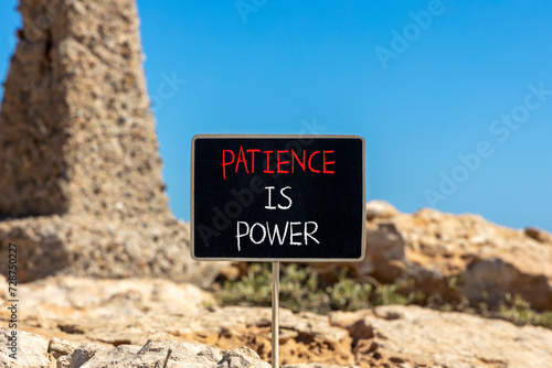 Patience is power symbol. Concept words Patience is power on beautiful black chalk blackboard. Beautiful red stone blue sky background. Business and patience is power concept. Copy space.