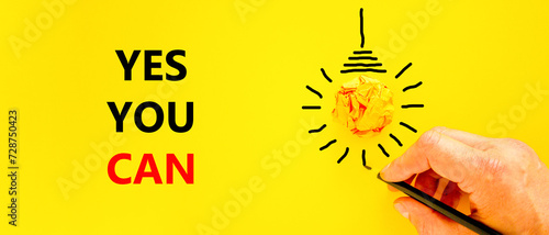 Motivational Yes you can symbol. Concept words Yes you can on beautiful yellow paper. Beautiful yellow background. Light bulb. Businessman hand. Business motivational Yes you can concept. Copy space