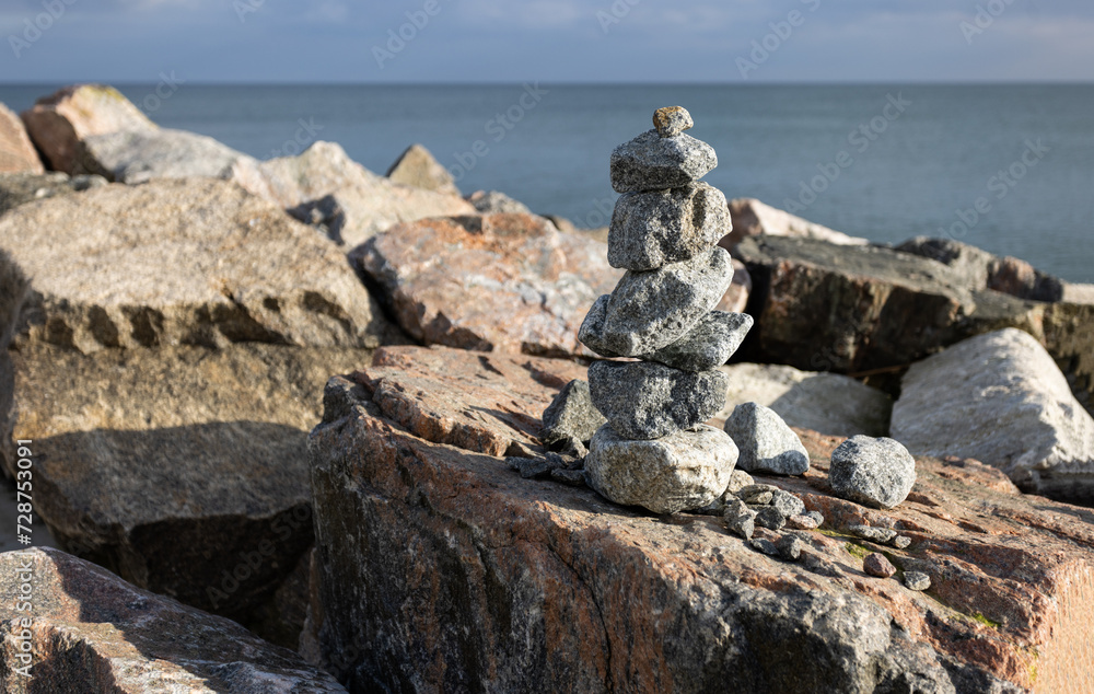 Balance and harmony, Japanese Zen stone garden background. Dark black granite stones on large symbolize concentration and relaxation. Rock Zen Pyramid - Concept of life balance, harmony and meditation