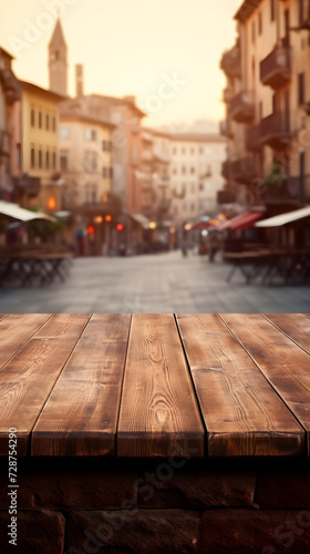 Rustic wooden table with a soft-focus background of a historic town in natural brown hues, table mock up for product © Maria Shchipakina