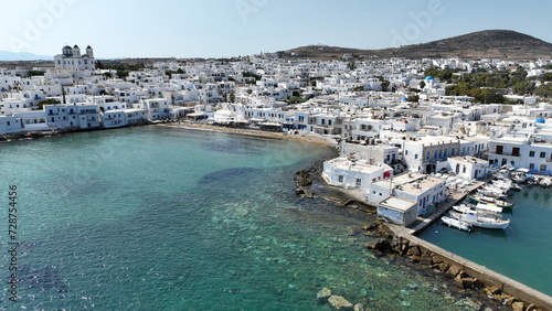 Aerial drone photo from picturesque small seaside village of Naoussa with traditional Cycladic character, Paros island, Cyclades, Greece © aerial-drone