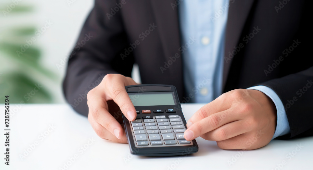 Blank calculator in male hands on a white table, Closeup Blank calculator in male hands on a white table, Closeup