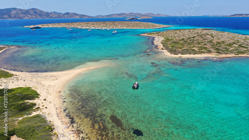 Aerial drone photo of azure paradise blue lagoon of Panteronisi a small islet complex between Paros and Antiparos islands visited by yachts and sail boats, Cyclades, Greece © aerial-drone