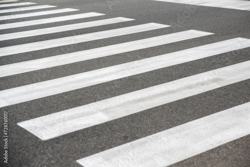 Closeup of zebra crossing on an empty street.