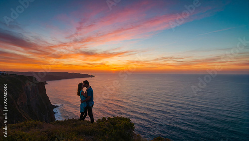 couple in love kissing on a cliff a sunset