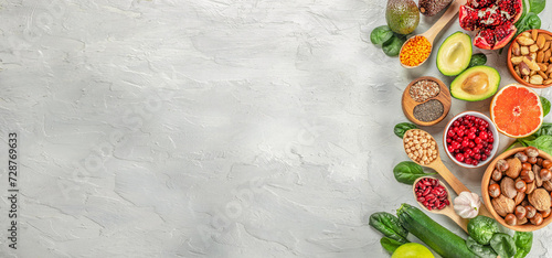 Healthy vegan food with fruits, vegetables, seeds, superfood, cereals. Foods high in vitamins, minerals and antioxidants. Long banner format. top view