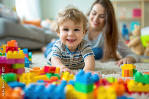 child and mother playing with colorful blocks at home 