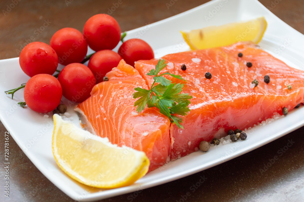 Juicy salmon fillet with tomatoes, lemon and herbs Juicy salmon fillet with tomatoes, lemon and herbs