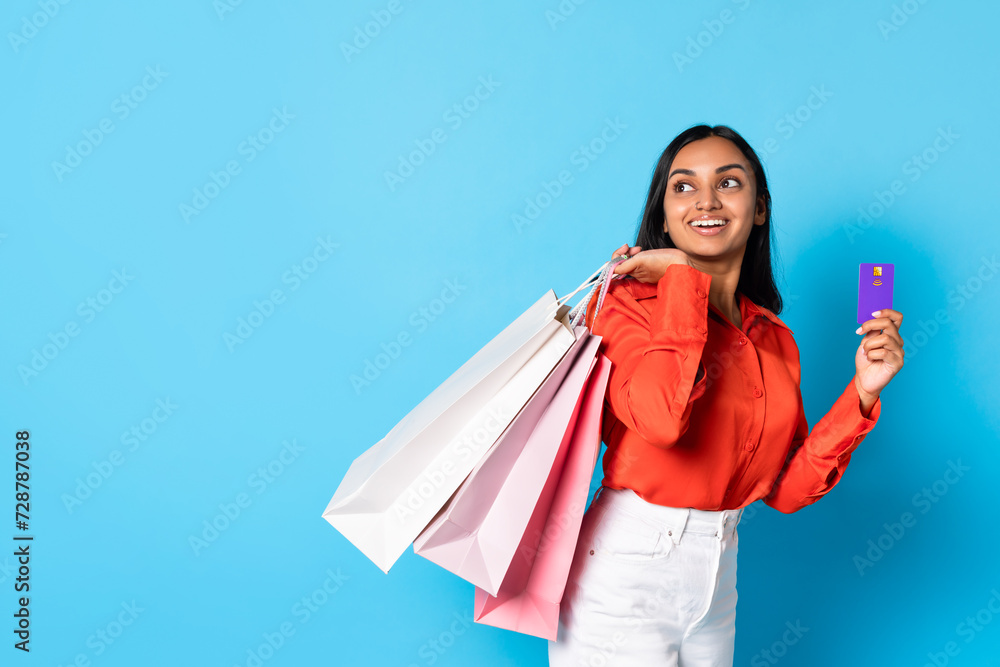 hindu customer lady holding credit card and shopper bags, studio hindu customer lady holding credit card and shopper bags, studio
