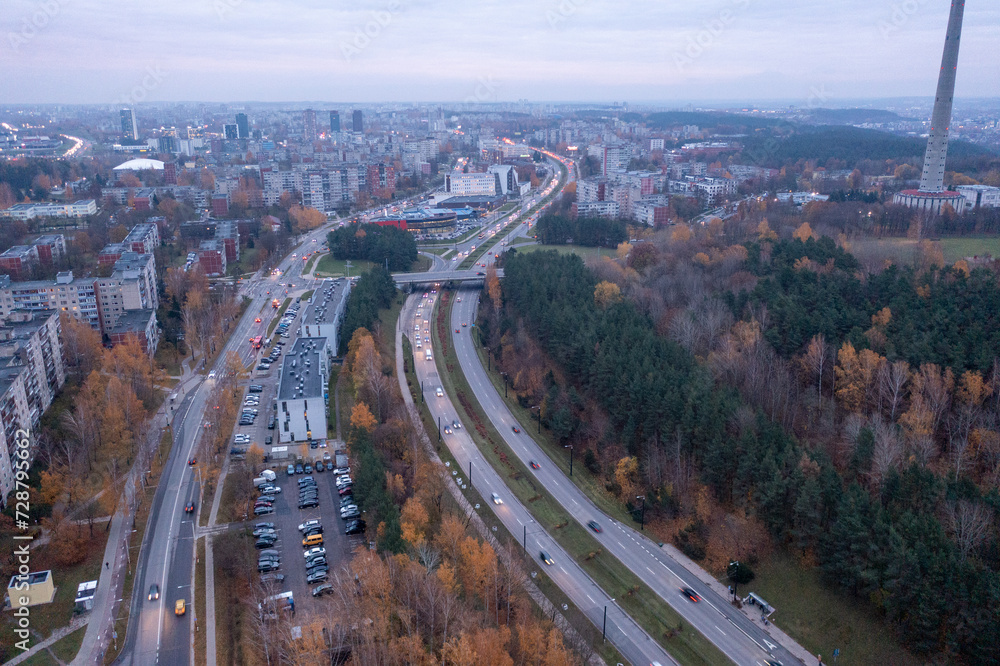 Drone photography of high intensity road traffic in a city during morning autumn morning rush hour .