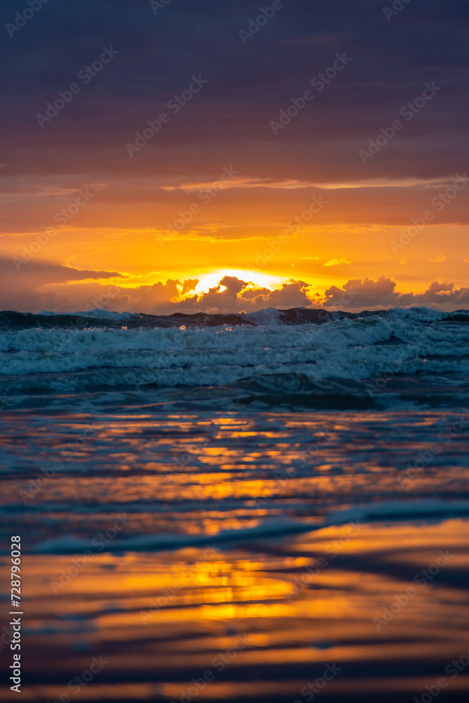 The sun setting into the sea