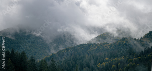 Clouds and fog over a mountain range of forest hills. Dramatic rainy weather. Carpathian mountains. Ukraine. © stone36