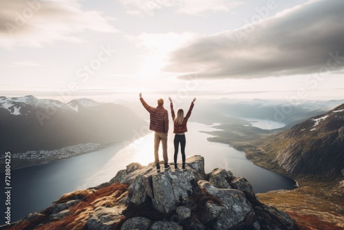 Adventurous couple standing on top of a mountain.