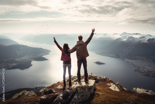 Man and woman standing on top of a mountain. © Marharyta
