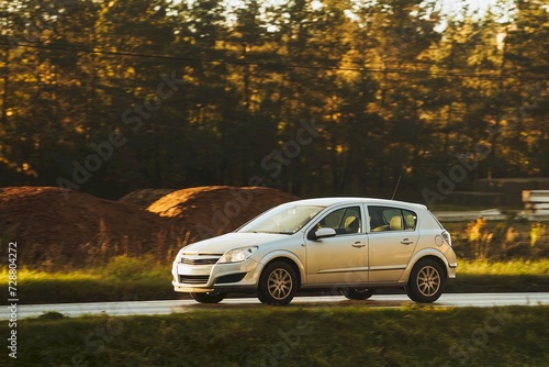 Compact family car moving on the interstate road. Fuel economy and safety of modern cars.