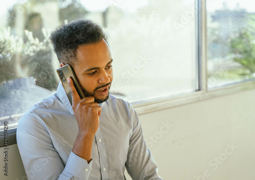 Businessman talking on the phone in the office.