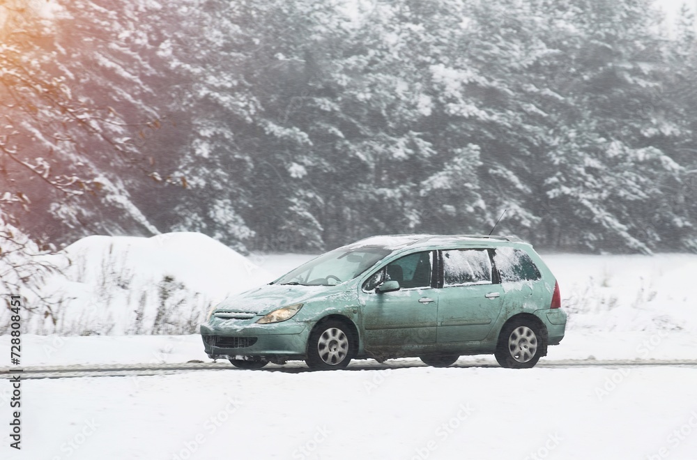 Car on a winter road. Dangerous driving conditions on the highway. Winter tires and undercarriage rust and corrosion concept. Slippery highway. Car on a winter road. Dangerous driving conditions on the highway. Winter tires and undercarriage rust and corrosion concept. Slippery highway.