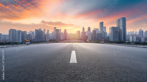 Empty asphalt road and modern city skyline with building scenery at sunset. high angle view