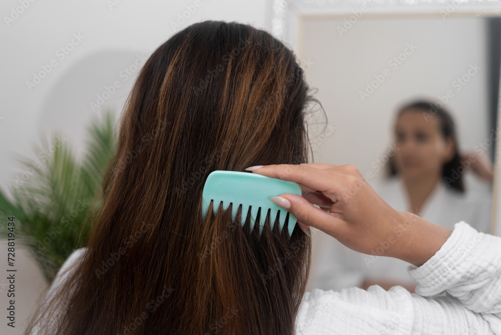 Home Haircare With A Closeup View She Meticulously Combs Her Long home-haircare-with-a-closeup-view-she-meticulously-combs-her-long
