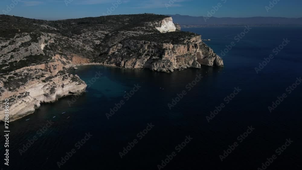 Aerial view with drone of the Sella del Diavolo in Cagliari. Sunny day, crystal clear sea with boats. Aerial view with drone of the Sella del Diavolo in Cagliari. Sunny day, crystal clear sea with boats.