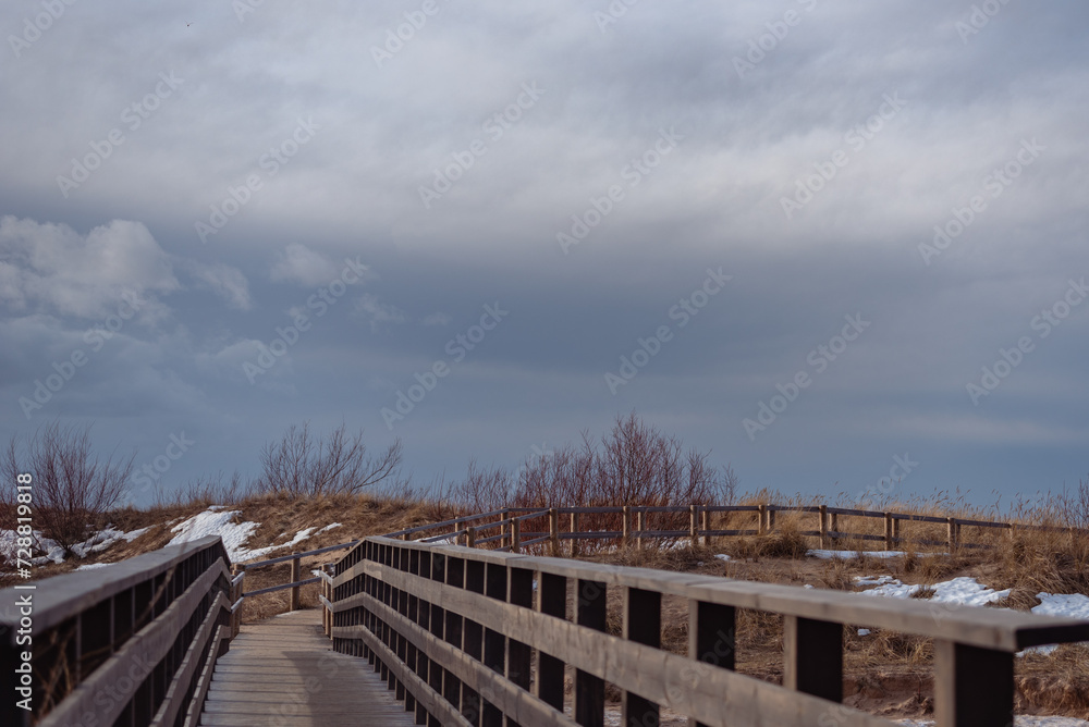Wooden bridge over Lilaste river on Baltic sea shore in winter
