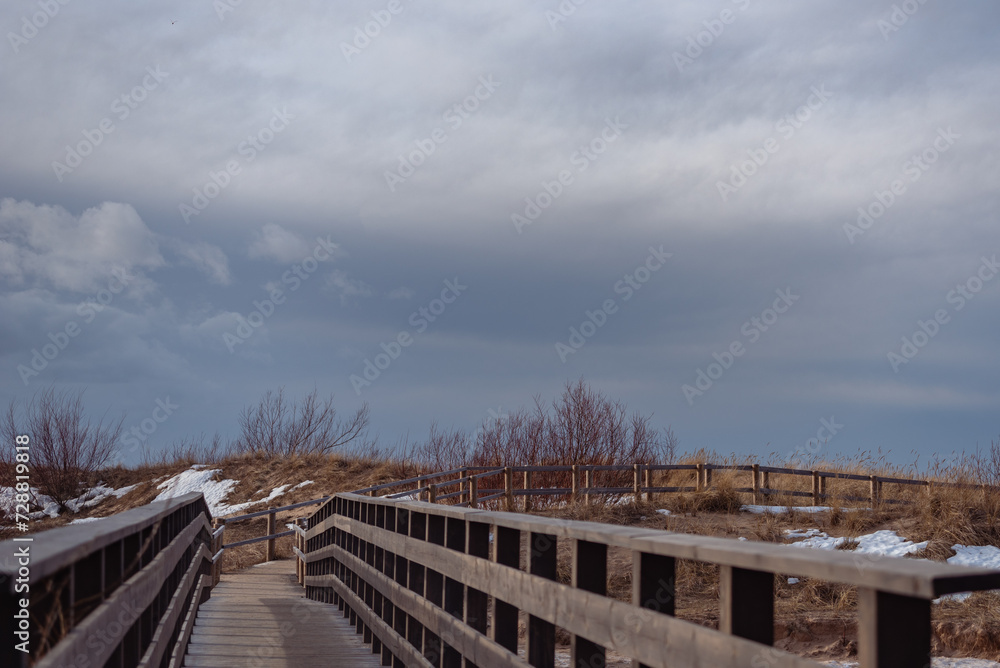 Wooden bridge over Lilaste river on Baltic sea shore in winter Wooden bridge over Lilaste river on Baltic sea shore in winter
