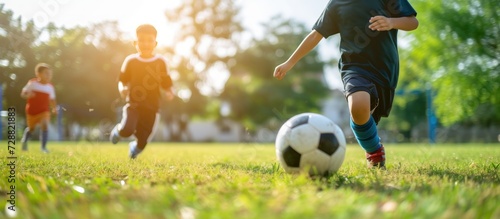 Happy children playing soccer football on outdoor grass field. AI generated image photo